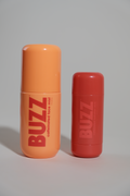 BUZZ Face Mist bottle and Hydration Stick standing together